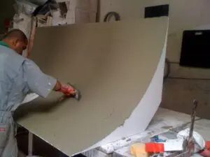 Man coating a cyclorama wall