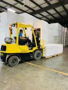 Yellow forklift carrying cyclorama walls