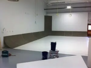 A room with two black cups on the floor